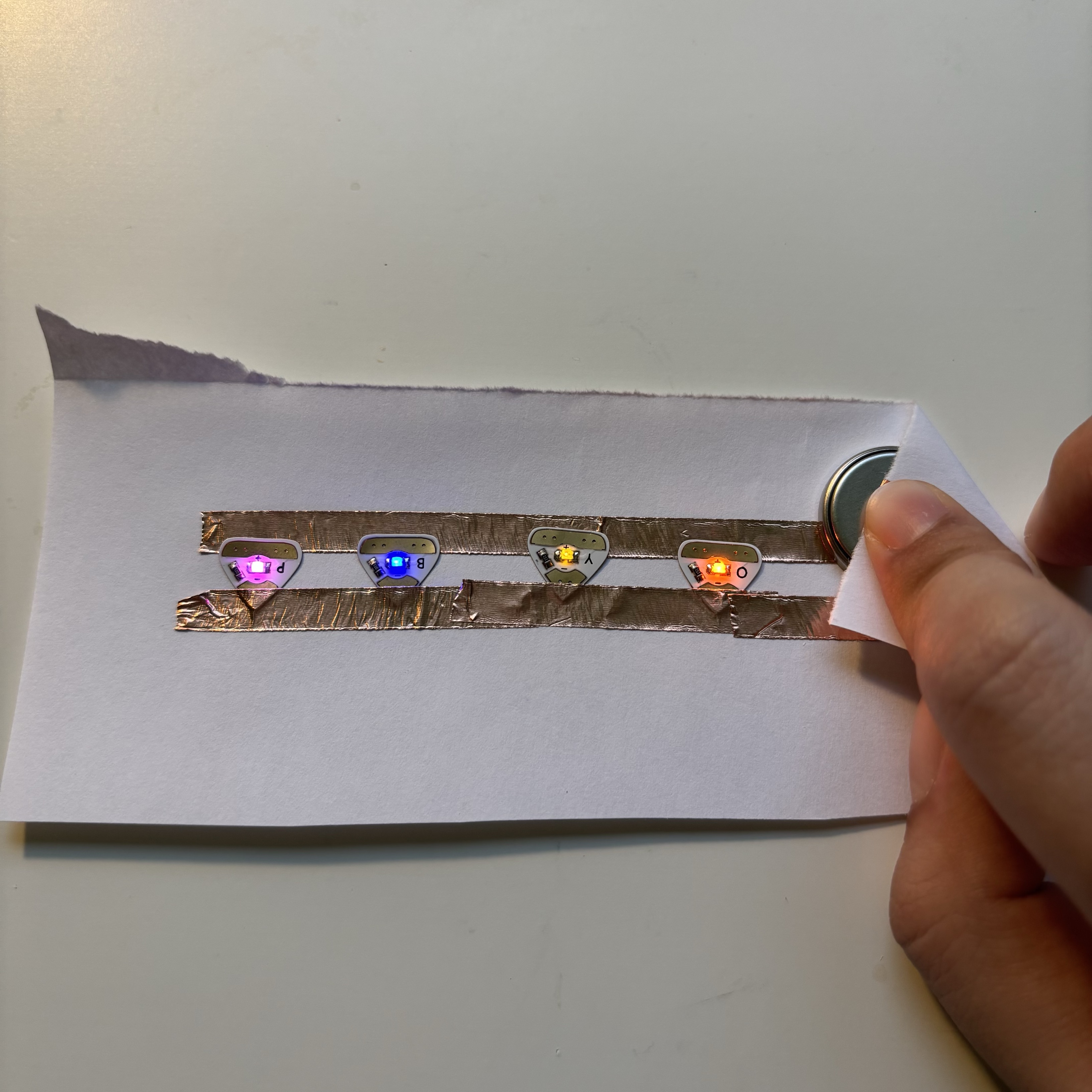 In this circuit, I combined the switch with a parallel connection. By folding the corners of the paper, the user turns the circuit on and can see the LEDs light up at the same time. I assume that this parallel connection will be used often in Final Design.