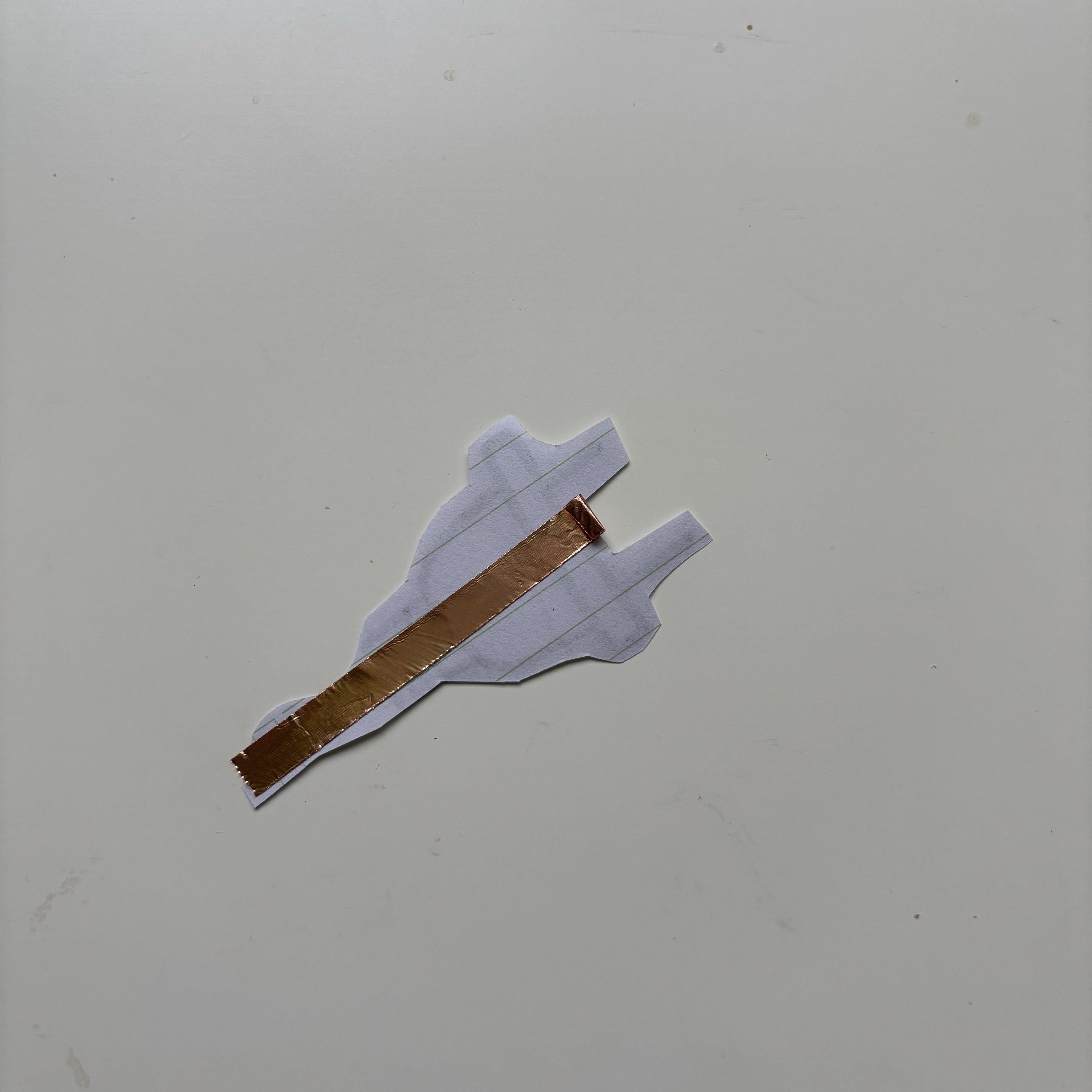 I drew a plug, cut it out, and put copper tape on the back of it, which will act as an switch for the circuit. I folded the end of the copper tape in hopes of simulating the damping sensation of a plug.