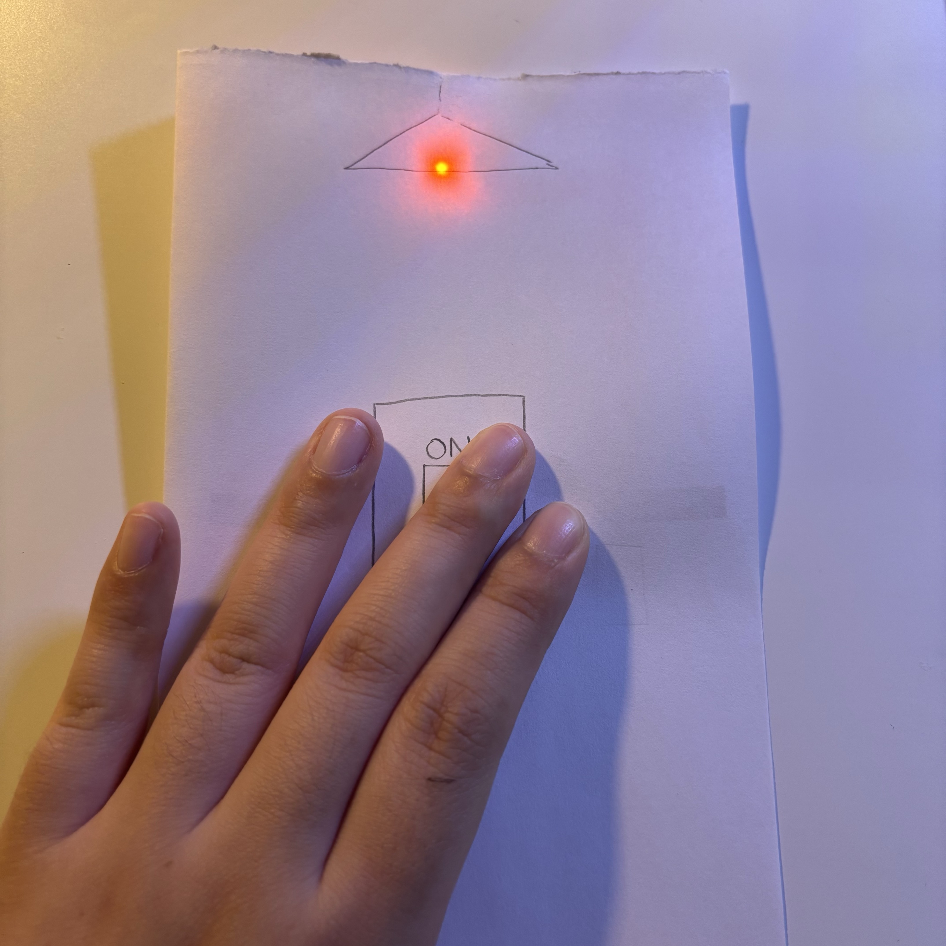 On this card, I added simple switching functionality that allows the user to control the LED's off and on by pressing the switch drawn on the paper.