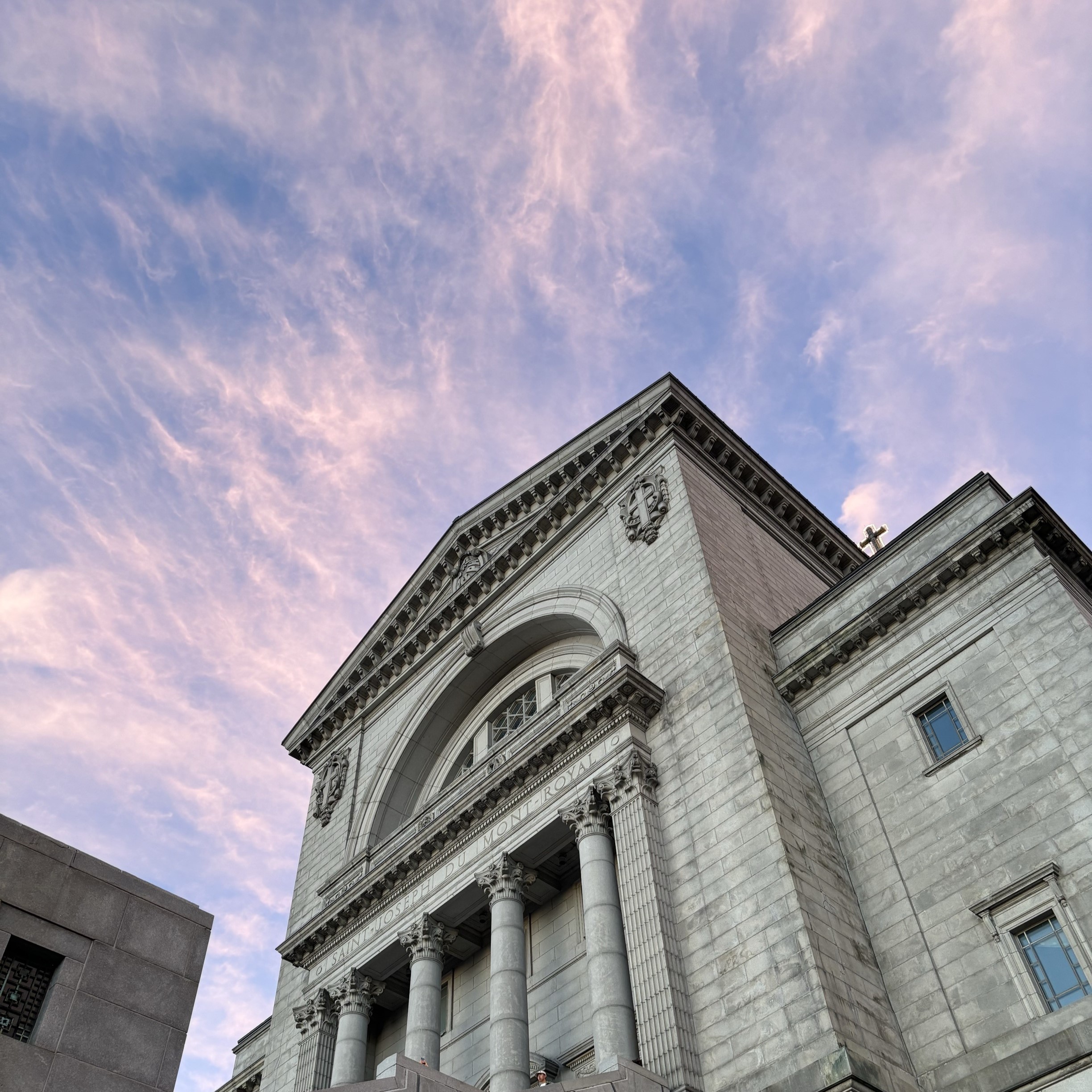 A sky shot looking up under Saint Joseph's Oratory of Mount Royal. I was on an outing with friends then, and we spotted the beautiful sunset, so we took pictures of it. This photo reminds me of the time I gathered with my friends, and the cozy evening sunshine makes it a special photo. My group members inferred from the photo that I am a person who loves to travel and is interested in religion and culture, and they could also see that I am a person who is good at finding the beauty of nature through this picture.