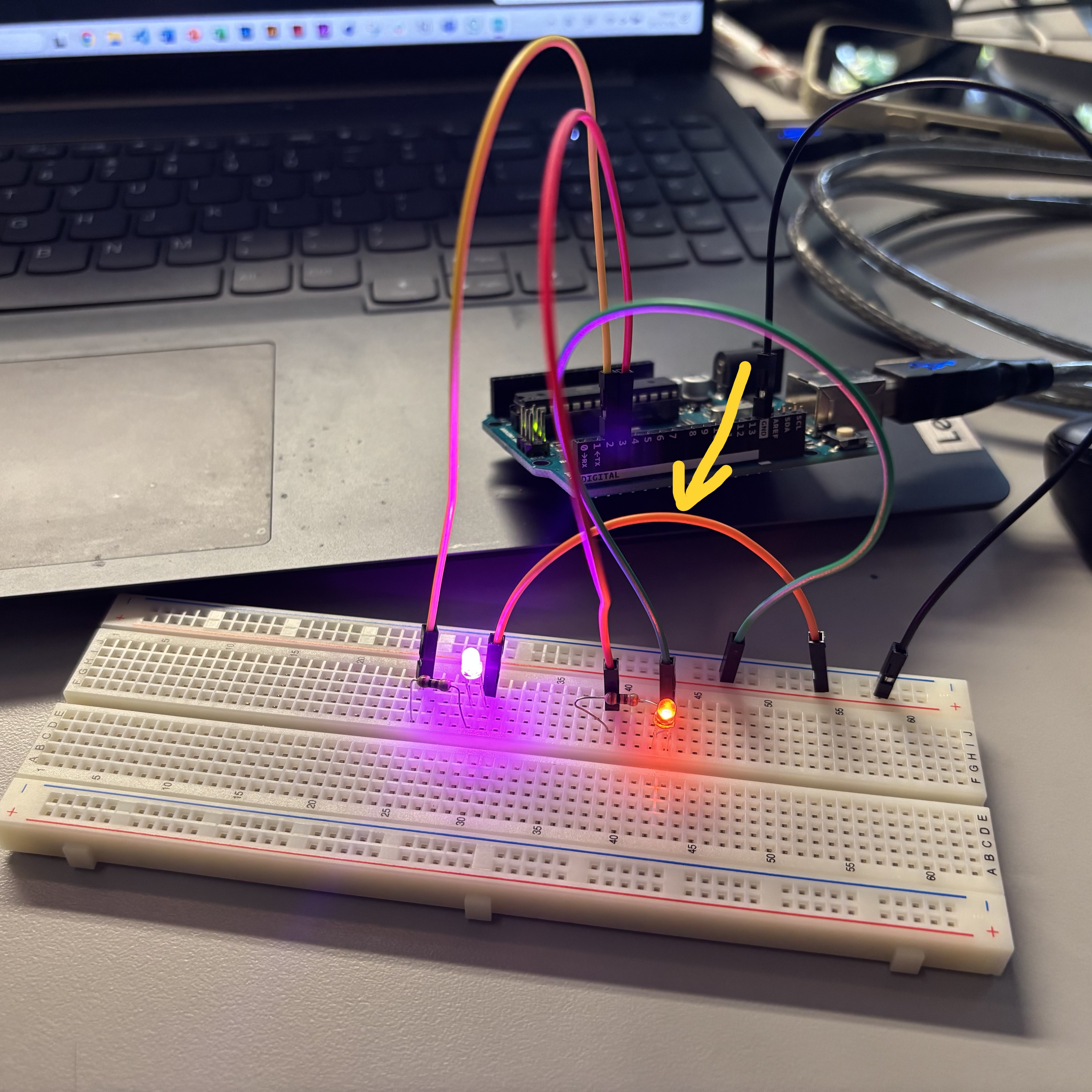 I debug the malfunction in Image 3 by adding a new resistor and LED, and by connecting the wire indicated by the yellow arrow. This formed a slightly more complex series circuit. At this point, both LEDs lit up and started blinking according to the Arduino sketch.
